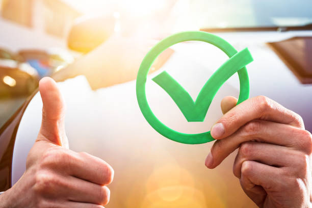 Close-up Of A Businessperson's Hand Holding Green Check Mark Icon