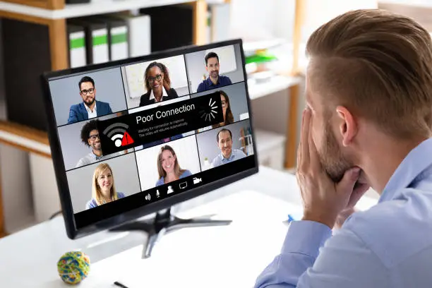 Worried Businessman Looking At Computer With Ransomware Word On The Screen At The Workplace