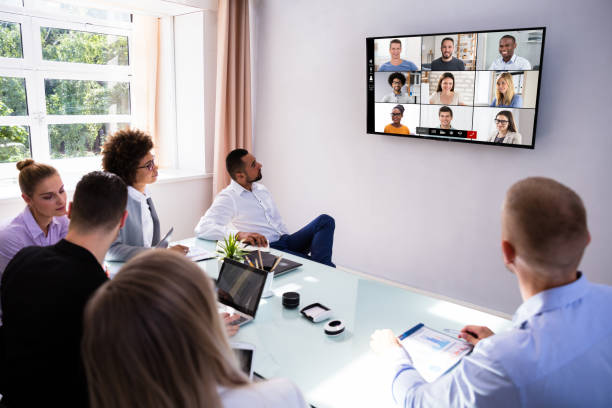 istock Businesspeople Video Conferencing In Boardroom 1322050403