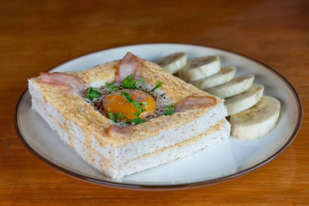 Modern breakfast, toasted bread, eggs, bacon on a wooden table. Good healthy food.