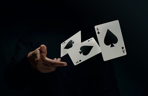 Ace Spade Playing Card. Player or Magician Flick and Levitating Poker Card by Hand. Front View. Closeup and Dark Tone