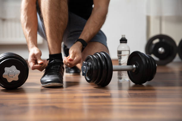 istock Man Tying Shoe Laces In Gym 1322050587