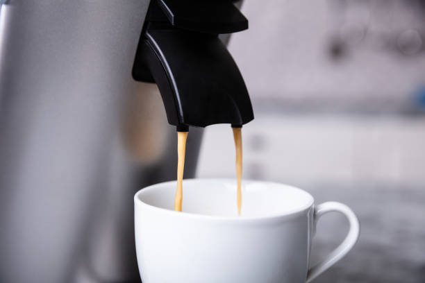 istock Espresso Machine Pouring Coffee Into A White Cup 1322052055
