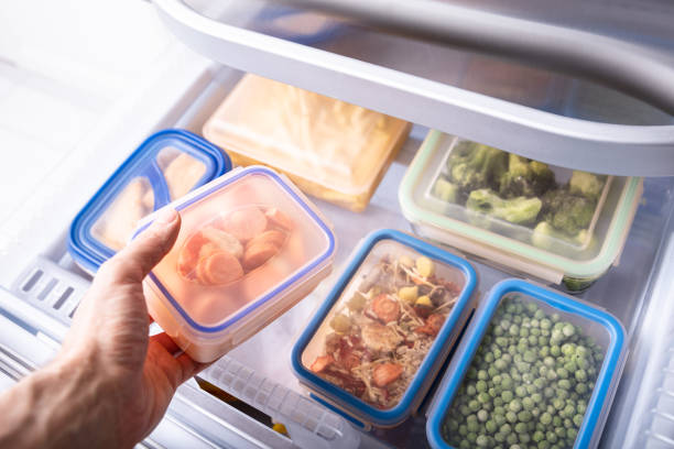 istock Man's Hand Taking Container Of Mixed Vegetables 1322052106
