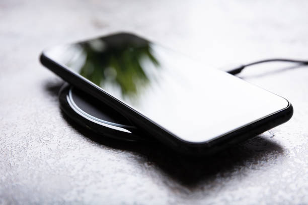 istock Wireless Charging Pad And Smartphone On Desk 1322052108