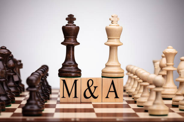 istock Chess Wooden Blocks With Mergers And Acquisitions Text 1322052245