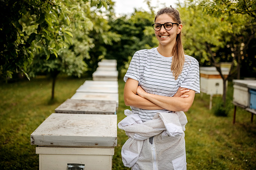 Young woman working as beekeeper