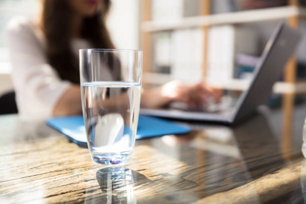 istock Glass Of Water On Desk 1322054896