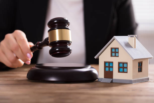 istock Judge Striking Gavel Near House Model 1322055141