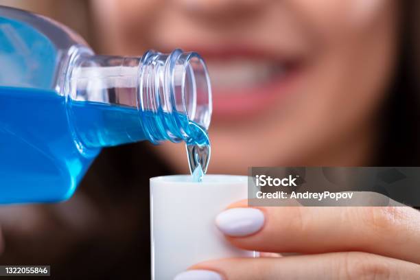 Woman Pouring Mouthwash Into Cap Stock Photo - Download Image Now - Mouthwash, Washing, Teeth