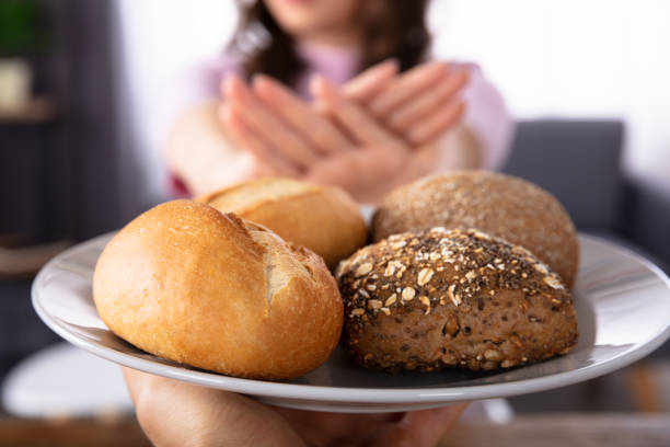 istock Woman Refusing Bread Offered By Person 1322056098