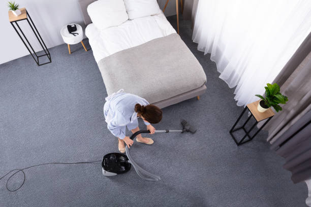 istock Housekeeper Cleaning Carpet With Vacuum Cleaner 1322056143