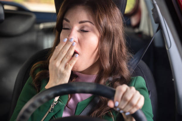 istock Woman Yawning Inside Car 1322056271