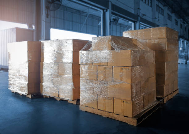 istock Stacked of Package Boxes Wrapped Plastic Flim on Pallets at Storage Warehouse. Shipment Boxes. Cargo Export- Import. Shipping Warehouse Logistics. 1322056484