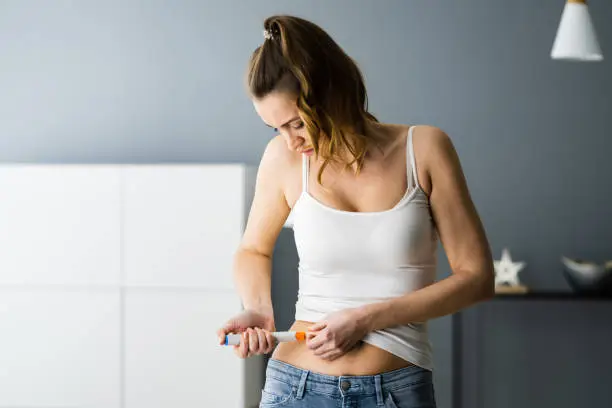 Medicament Self Injection In Belly Using Syringe With Drug