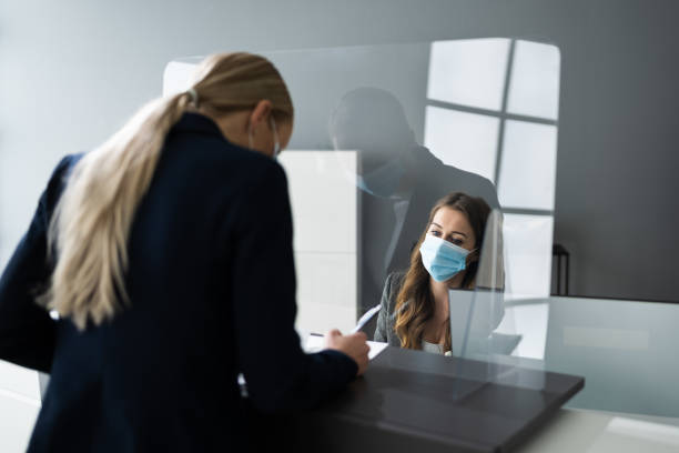 istock Hotel Reception Desk Protected By Medical Mask 1322057332