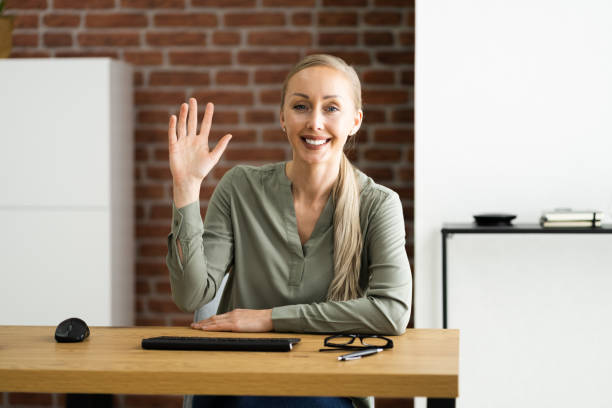 istock Woman Portrait Waving To Webcam 1322057591