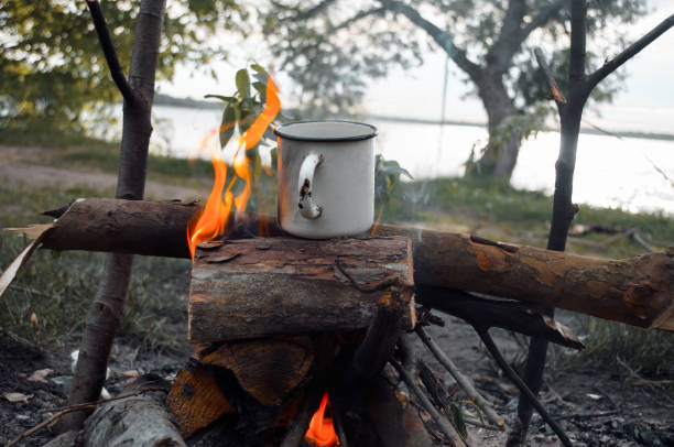 istock Iron mug with a drink on the fire. Cooking outdoor camping. Hike concept 1322061585