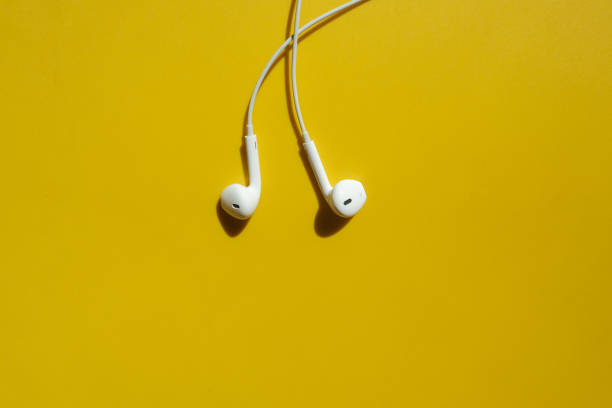 istock white earphones or earbuds on yellow background 1322063535