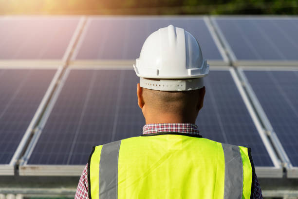 istock Young asian electrical engineer standing in front of Solar cell panels farm. He checking and installing. Solar generator power concept. 1322065243