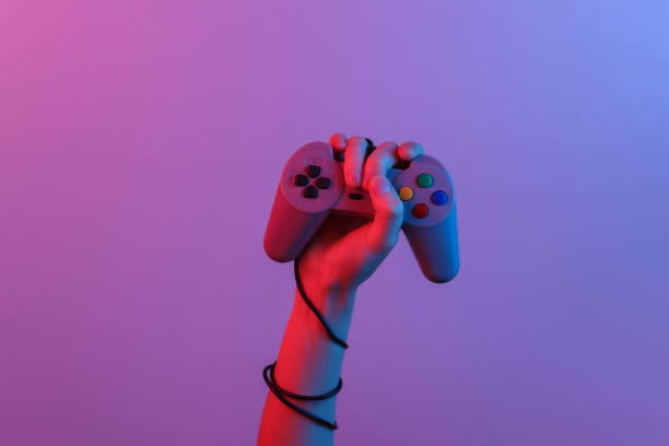 istock Hands holding retro joystick in blue-red neon gradient light. Old gaming. 80s retro wave. Minimalism 1322069367