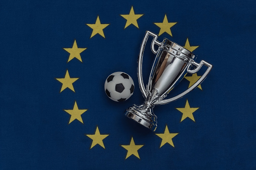 Champion cup with soccer ball on EU flag. Sport competitions