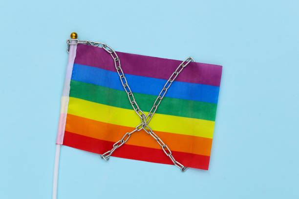 istock LGBT rainbow flag wrapped in steel chain. Intolerance 1322072065