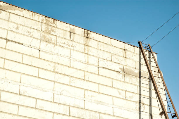 istock Modern warehouse building with an iron staircase casting shadow on te wahite wall 1322072685