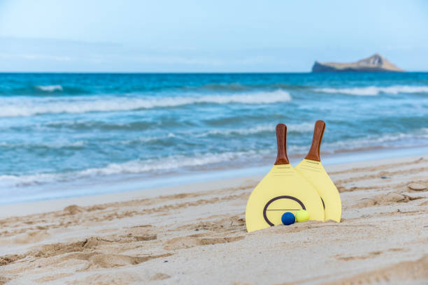 istock Yellow beach paddle and balls on a beach in Hawaii 1322072800