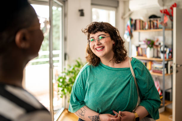 A young woman came to visit her friend A young woman came to visit her friend. They didn't see each other for a long time plus size stock pictures, royalty-free photos & images