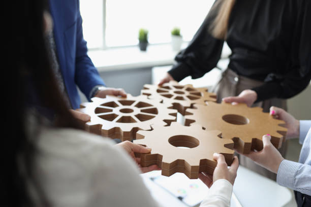 istock Efficient business team connects wooden gears into one 1322073930