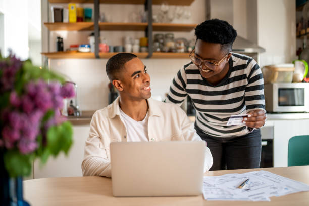 istock Young couple paying online with a credit card 1322074004