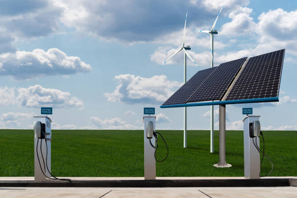 Charging stations for electric vehicles Charging stations for electric vehicles on a background of solar panels and wind turbines alternative fuel vehicle stock pictures, royalty-free photos & images