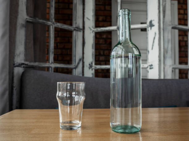 istock Transparent empty glass bottle for water or wine and empty glass. 1322080359