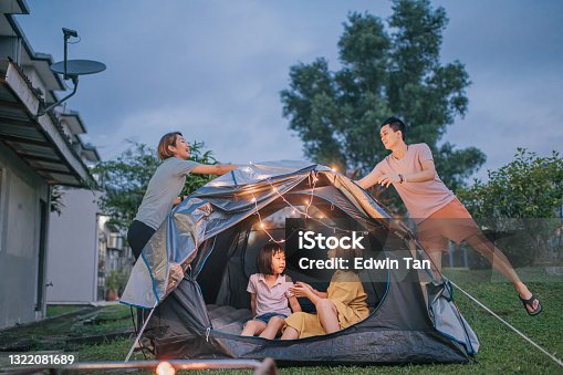 istock Asian chinese family putting on string light decorating camping at backyard of their house staycation weekend activities 1322081689