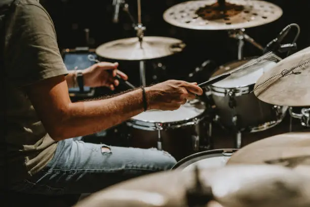 Photo of Man Playing Drums At Music Concert