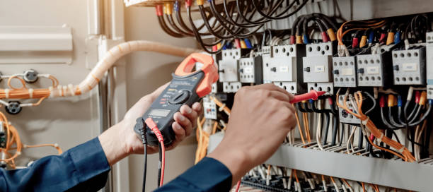 istock Electrician engineer uses a multimeter to test the electrical installation and power line current in an electrical system control cabinet. 1322083198