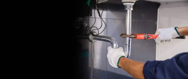 istock Plumber fixing white sink pipe with adjustable wrench. 1322083215