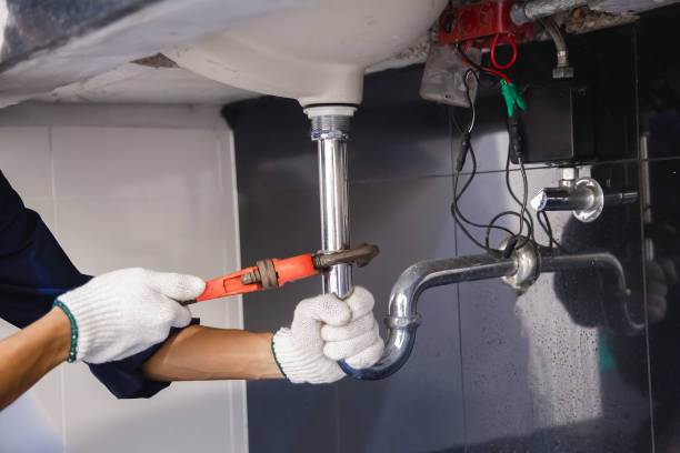 istock Plumber fixing white sink pipe with adjustable wrench. 1322083244
