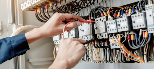 istock Electrician engineer uses a multimeter to test the electrical installation and power line current in an electrical system control cabinet. 1322083286