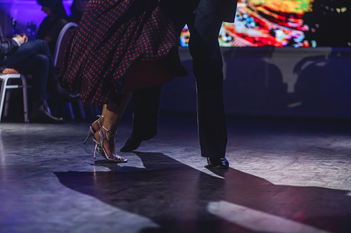 Portrait of young people dancing lindy hop in pairs in modern dance hall