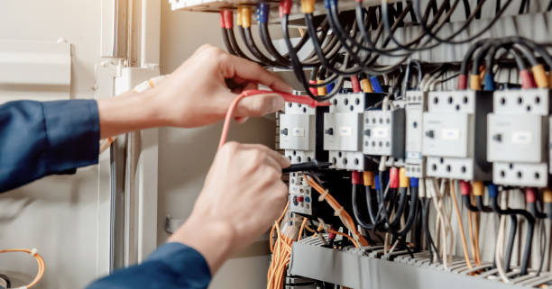 istock Electrician engineer uses a multimeter to test the electrical installation and power line current in an electrical system control cabinet. 1322083290