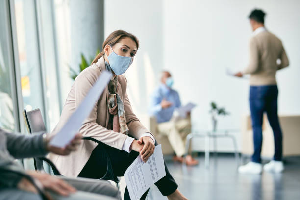 istock Thoughtful female candidate waiting for job interview during coronavirus pandemic. 1322089066