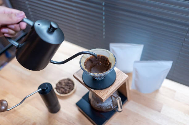 istock Hand drip coffee, Barista making drip coffee with mockup blank package coffee Alternative ways of brewing Coffee shop concept. 1322093861