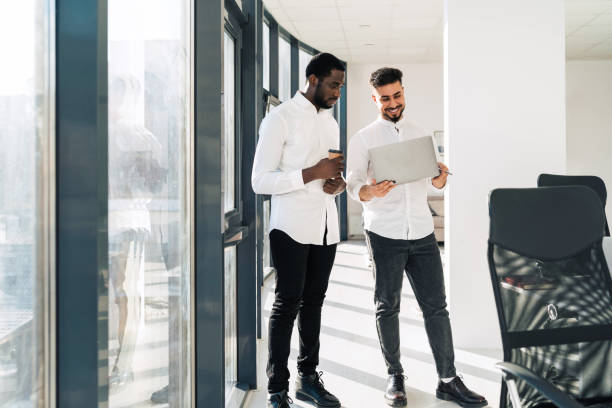 istock Two interracial businessmen with laptop in the office 1322097004