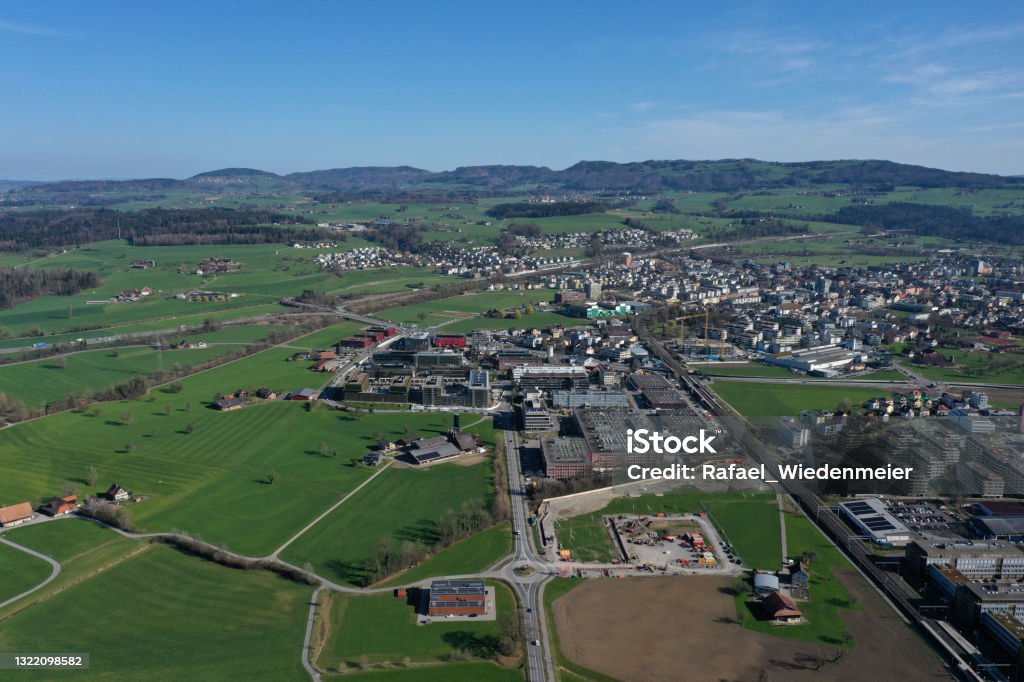 Canton of Zug with Baar Canton of Zug with Baar. Zug itself is a small town in central switzerland with arround 30'000 residents. The high angle image was captured during a beautiful day in springtime. Agricultural Field Stock Photo