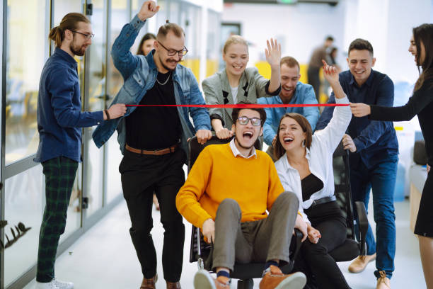 istock Young colleagues group having fun together, riding on chairs in office, diverse excited office workers enjoying break, laughing, engaged funny activity, celebrating corporate success. 1322099981