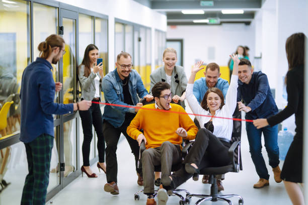 istock Young colleagues group having fun together, riding on chairs in office, diverse excited office workers enjoying break, laughing, engaged funny activity, celebrating corporate success. 1322100086