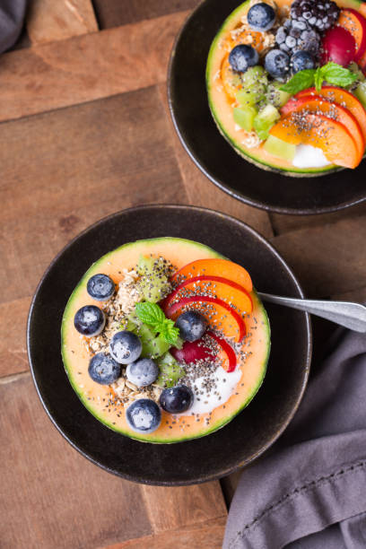 istock Fruit salad with yogurt in carved melon cantaloupe bowl 1322100096