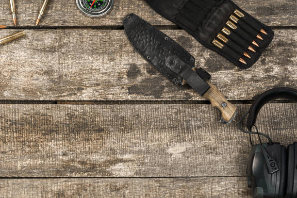 istock Hunting equipment on old dark wooden background 1322101022